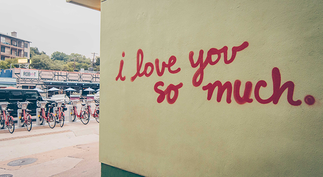 A photograph of a wall in Austin, Texas, with the words "i love you so much" written on it.