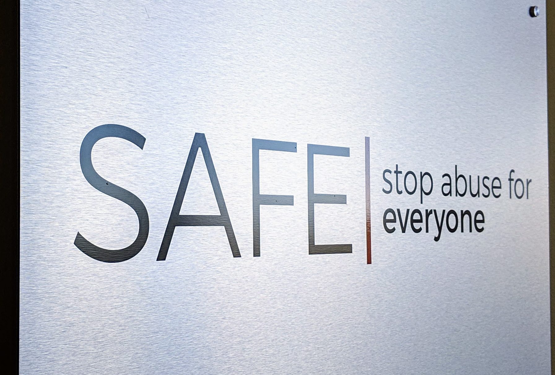 A photo of the SAFE logo printed on a steel panel