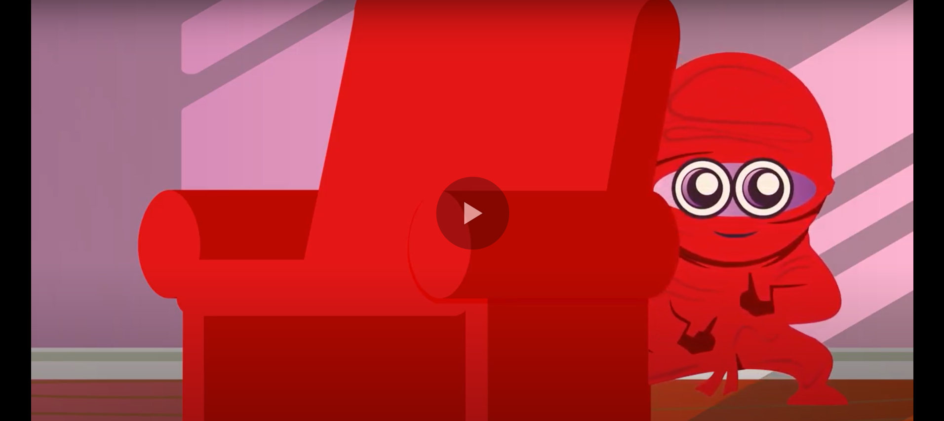 Image description: A screenshot from an animated video. A cartoony child dressed in a red ninja costume is hiding behind a red recliner. A small play icon is in the middle of the image.