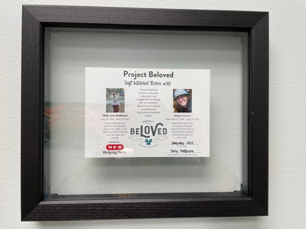 Image description: A plaque hung on the wall of the soft interview room describing the Project Beloved and the reason for their work. 