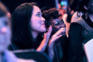 Image description: A photo teens in a crowd during a performance.