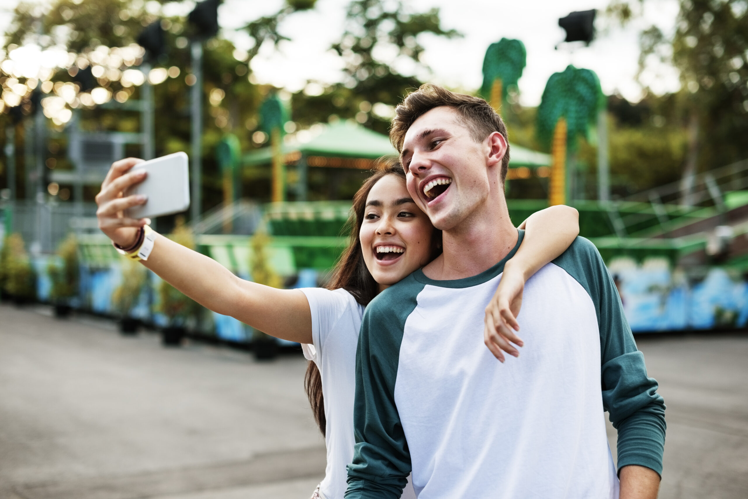 Teenage couple taking selfie together.